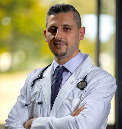 Dr. Maath J Alani, M.D. Profile picture with lab coat and Stethoscope 